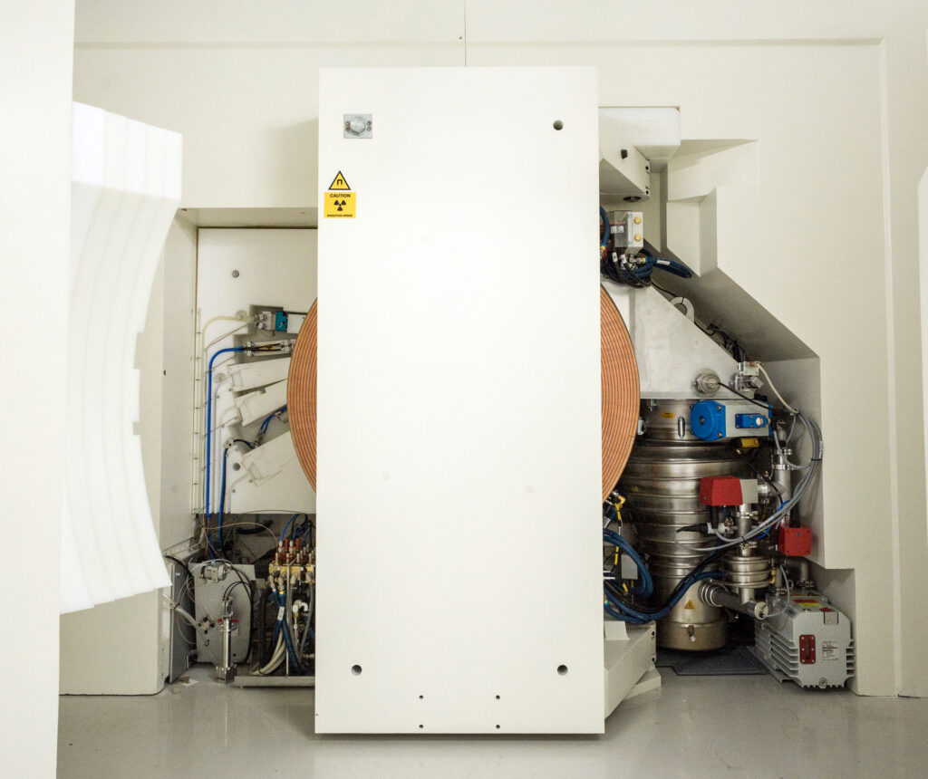 Cyclotron with the radiation shield open, showing the targets (left), the magnet and the cyclotron (centre), and the vacuum system (right) (Photo: S.F. Sämmer)